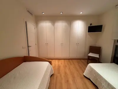 a bedroom with two beds and white cabinets at Relaxing Sea View Apartment - Patacona Beach in Valencia