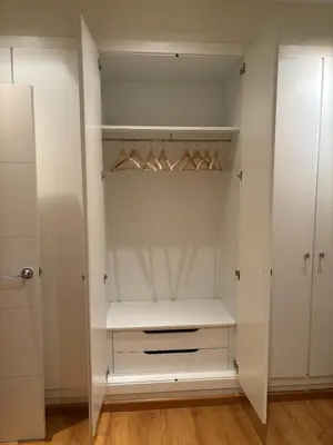 a walk in closet with white cabinets and wooden floors at Relaxing Sea View Apartment - Patacona Beach in Valencia