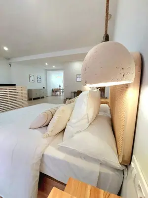 a large bed with white pillows and a lamp at Excepcional moderno y luminoso Terraza privada in Valencia