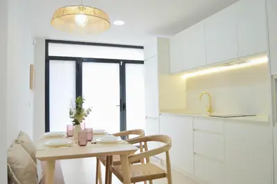 a kitchen with a table and chairs in a kitchen at Excepcional moderno y luminoso Terraza privada in Valencia