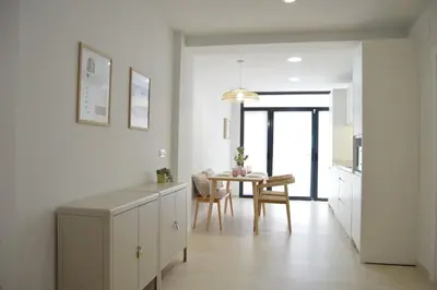 a kitchen with a table and a dining room at Excepcional moderno y luminoso Terraza privada in Valencia