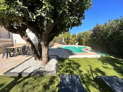 a swimming pool with a tree and a table at Casa Mar in Valencia
