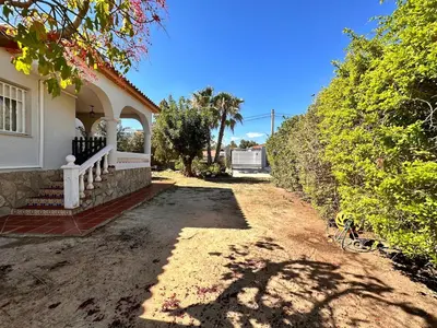 a house with a porch and a dirt road at Casa Mar in Valencia