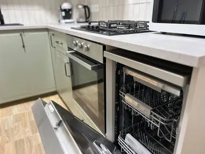 a kitchen with an oven with its door open at Pearl by the sea in Valencia