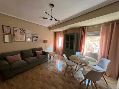 a living room with a couch and a table and chairs at Pearl by the sea in Valencia