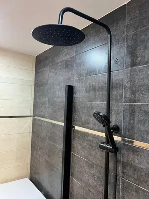 a shower with a shower head in a bathroom at Pearl by the sea in Valencia