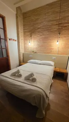 a bedroom with a large bed with towels on it at Casita Buenos Aires in Valencia