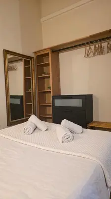a bedroom with a bed with two towels on it at Casita Buenos Aires in Valencia