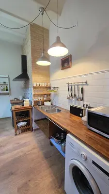 a kitchen with a sink and a washing machine at Casita Buenos Aires in Valencia