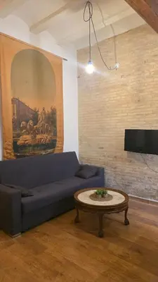 a living room with a blue couch and a table at Casita Buenos Aires in Valencia