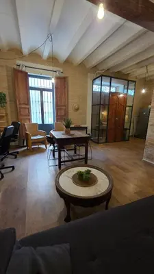 a living room with a couch and a table at Casita Buenos Aires in Valencia