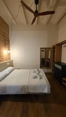 a bedroom with a bed and a ceiling fan at Casita Buenos Aires in Valencia