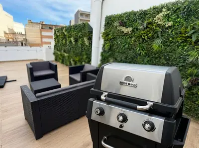 a grill sitting on top of a patio at Ático Premium Centro de Tavernes, Terraza & BBQ in Tavernes de Valldigna