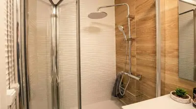 a shower with a glass door in a bathroom at Ático Premium Centro de Tavernes, Terraza & BBQ in Tavernes de Valldigna