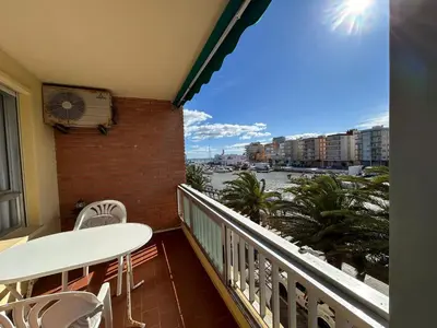 a balcony with a table and chairs and a view of the water at Apartamento Perellonet Mascaró in El Perellonet