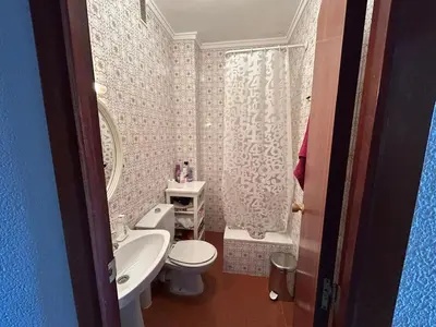 a bathroom with a white toilet and a sink at Apartamento Perellonet Mascaró in El Perellonet