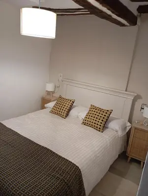 a bedroom with a bed with two pillows on it at Casa La Villa in Requena
