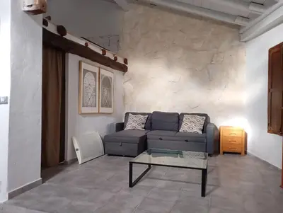 a living room with a couch and a table at Casa La Villa in Requena