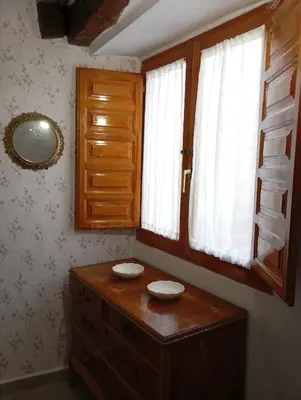 a room with a wooden dresser and a window at Casa La Villa in Requena