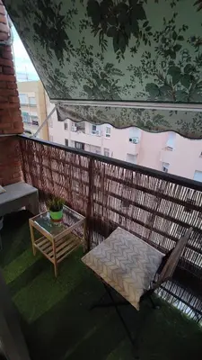 a balcony with a bench and a table and a building at Fabulous apartment in Valencia, Campanar in Valencia