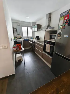 a kitchen with a stainless steel refrigerator and a table at Fabulous apartment in Valencia, Campanar in Valencia
