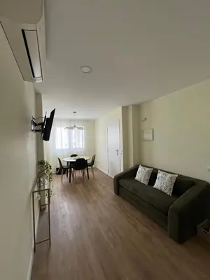 a living room with a couch and a kitchen at Puzol Playa in Puzol