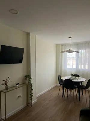 a kitchen with white cabinets and a washer and dryer at Puzol Playa in Puzol