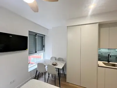 a kitchen and dining room with a table and chairs at Loft en el Centro De Valencia Botánico 2 in Valencia