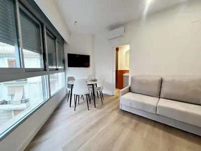 a living room with a couch and a table at Loft en el Centro De Valencia Botánico 3 in Valencia