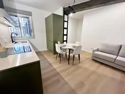 a kitchen and dining room with a table and a couch at Loft en el Centro De Valencia Botánico 5 in Valencia