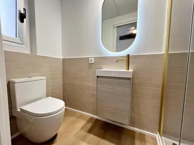 a bathroom with a toilet and a sink and a mirror at Loft en el Centro De Valencia Botánico 5 in Valencia