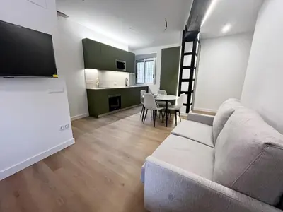 a living room with a couch and a table and a kitchen at Loft en el Centro De Valencia Botánico 5 in Valencia