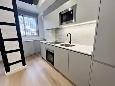 a white kitchen with a sink and a microwave at Loft en el Centro De Valencia Botánico 6 in Valencia