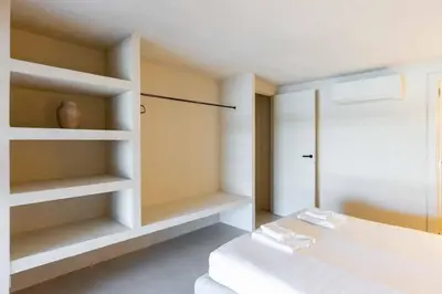 a bedroom with white shelves and a bed at VLC Host - Reina 166 B in Valencia