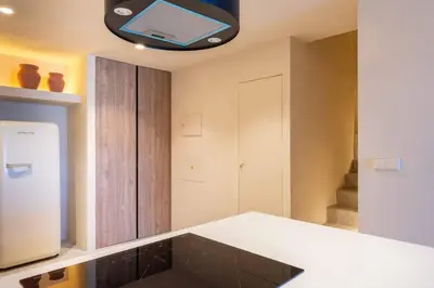 a kitchen with a white counter with a laptop on the ceiling at VLC Host - Reina 166 B in Valencia