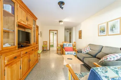 a living room with a couch and a tv at Apartment Patacona Beach 7 in Valencia