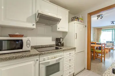a kitchen with a microwave and a stove top oven at Apartment Patacona Beach 7 in Valencia