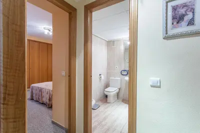 a bathroom with a toilet and a room with a bed at Apartment Patacona Beach 7 in Valencia
