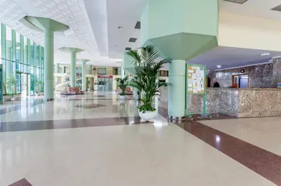 a lobby with a plant in the middle of a building at Apartment Patacona Beach 6 in Valencia