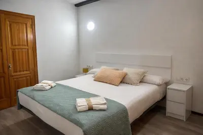 a bedroom with a bed with two towels on it at Mini Peixcateria in Sagunto