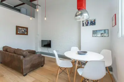 a living room with a couch and a table and chairs at Apartment Ruzafa Puerto Rico in Valencia