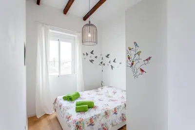 a white bedroom with a bed and a window at Apartment Ruzafa Puerto Rico in Valencia