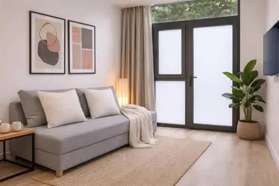 a living room with a couch and a window at Roig Arena Suite Garden N9 in Valencia