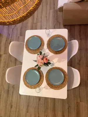 a table with green plates and flowers on it at Las Casitas de Cullera Sol y Mar in Cullera