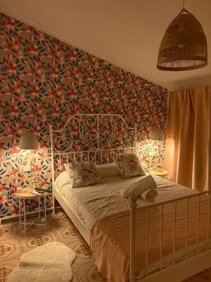 a bedroom with a bed and a tv on a wall at Las Casitas de Cullera Sol y Mar in Cullera