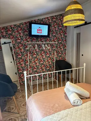 a bed in a room with floral wallpaper at Las Casitas de Cullera Sol y Mar in Cullera