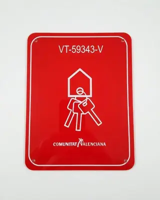 a red sign with a person holding a hammer at Las Casitas de Cullera Sol y Mar in Cullera