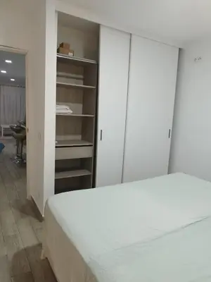 a bedroom with a white bed and a closet at Valencia Room in Cuart de Poblet