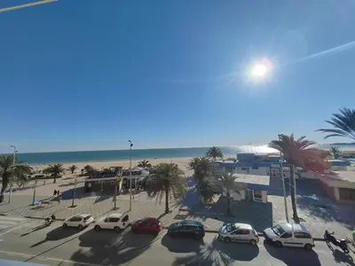a group of cars parked in a parking lot near the beach at Maravillosa vistal'mar in Puerto de Sagunto
