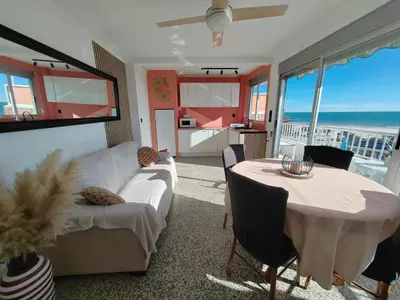 a living room with a white couch and a table at Maravillosa vistal'mar in Puerto de Sagunto